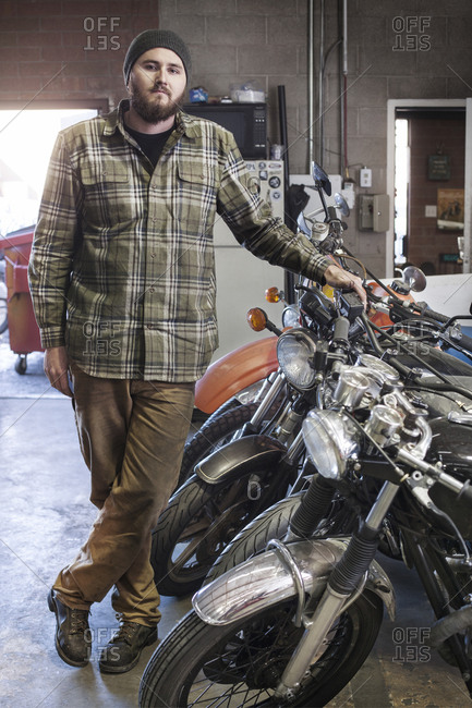 Portrait of a mechanic in a shop with motorcycles