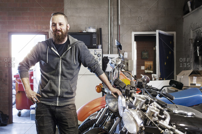 Portrait of a mechanic in a garage with motorcycles