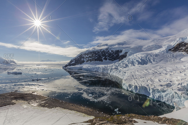 Ice choked waters surrounded by ice-capped mountains and glaciers in Neko Harbor, Antarctica