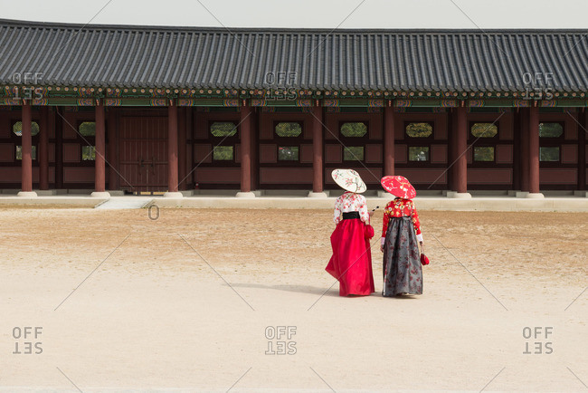 Two young women with parasols at Gyeongbokgung Palace, Seoul