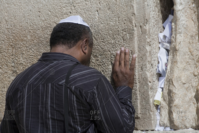 Jewish worshipper in prayer at the sacred Western Wall of the Temple Mount in Old Jerusalem, Israel