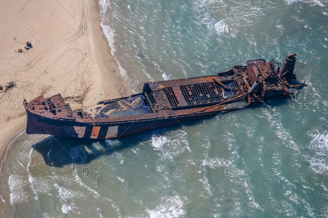 Stranded ship wreck at seafront seen from above in Lesina, Italy