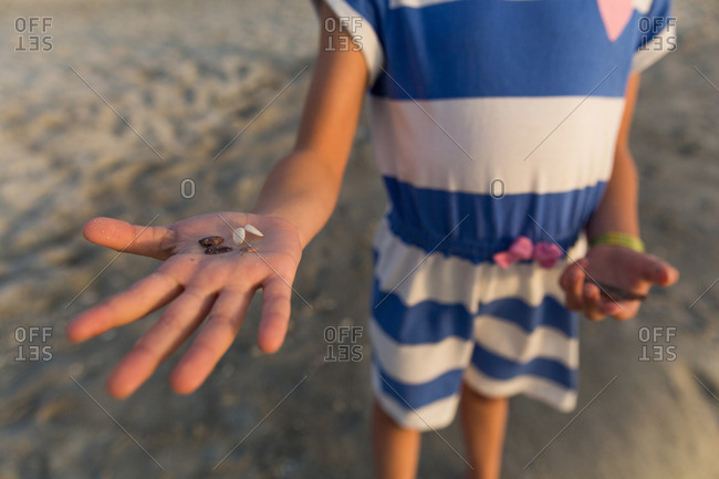 Girl showing off shell finds