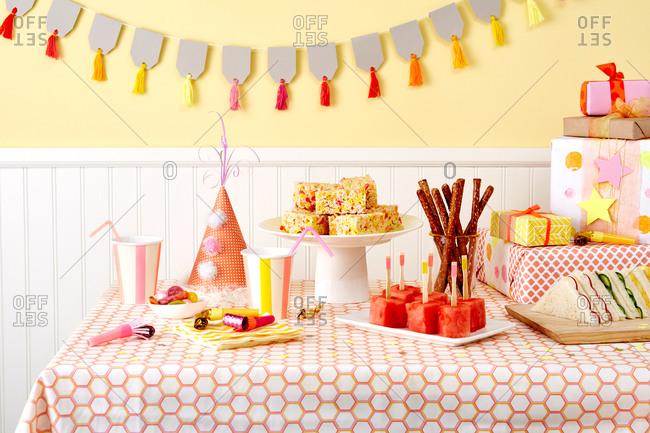A room decorated for a birthday party filled with gifts and food