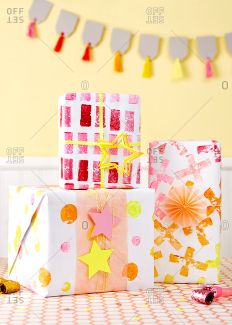 Gifts wrapped in potato stamped wrapping paper at a birthday party