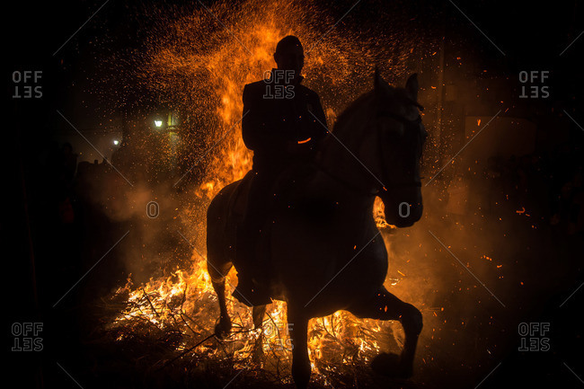 A horseman jumps a bonfire to purify his horse during the Saint Anthony festival, Spain