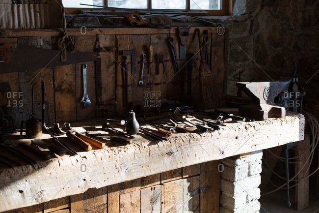 Tools and anvil on workbench in an old tool shed
