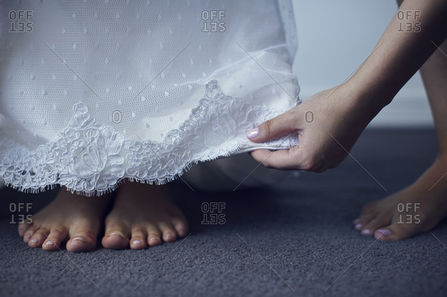 Hem of a bride\'s dress and her blistered feet