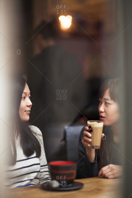 Two young friends in cafe bar