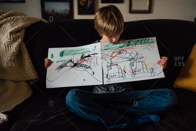 Boy sharing his drawing of police cars