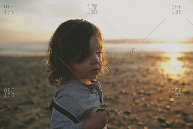 Portrait of a little boy with suspenders at sunset
