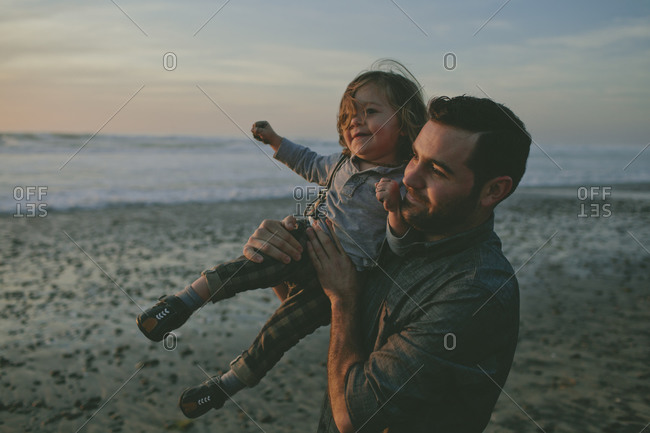 Father lifting toddler up in the air