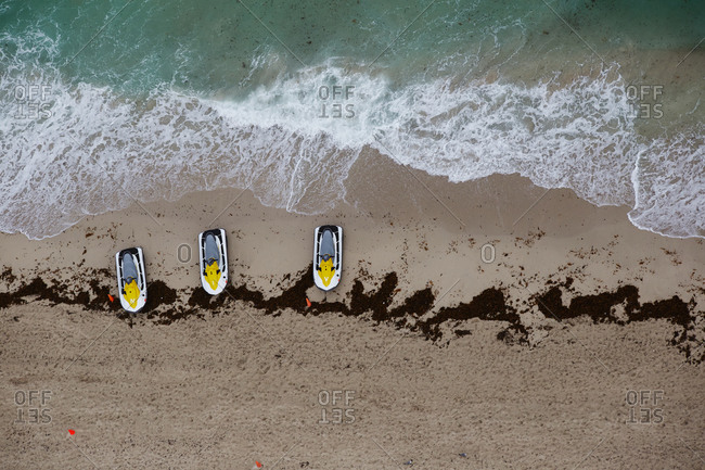 Three jet skis parked on the coast of Miami, FL