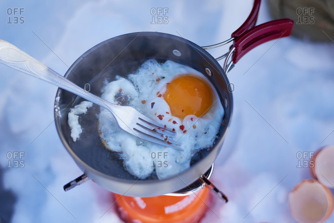 Eggs in a pot over a single burner campstove