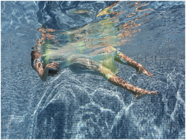 Underwater woman floating in water