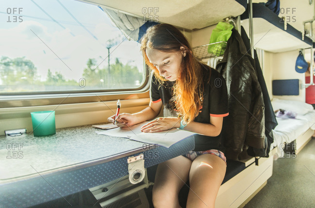 Girl writing on train | Stock Images Page | Everypixel