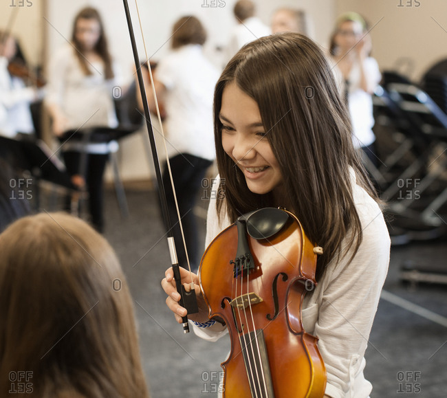 Student playing violin in music class