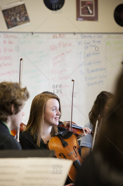 Students playing violins in music class