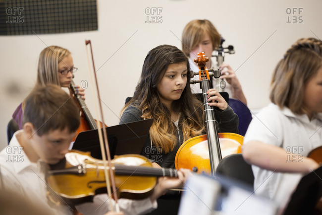 Students playing string instruments in music class