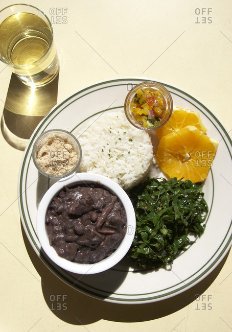 Cuban food on a plate with a drink