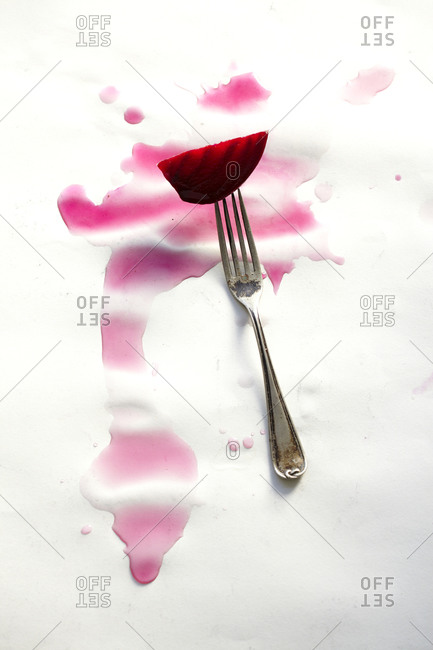 Beet slice on a fork with beat juice