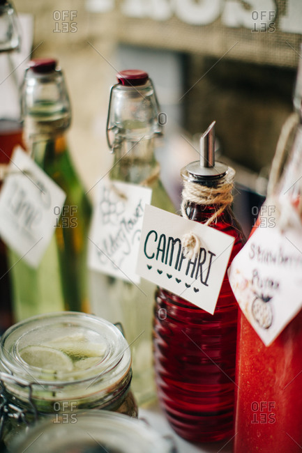 Rustic bottles of liquor labeled with tags on bar