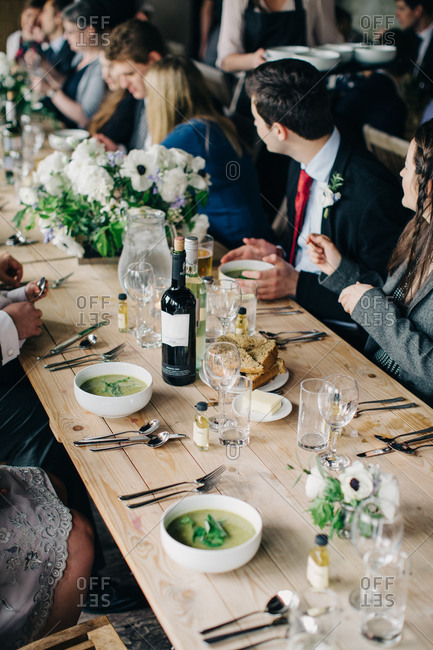 Soup served to guests seated at long wedding reception table