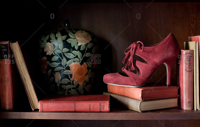High heel on a bookshelf