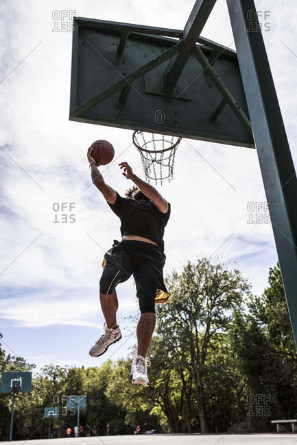 Man leaping for basketball dunk