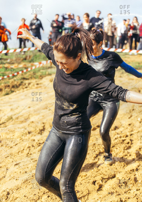 Two Woman Running Through Mud In An Extreme Obstacle Race Stock Images Page Everypixel 