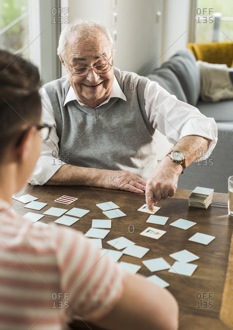 Senior man playing memory with his grandson