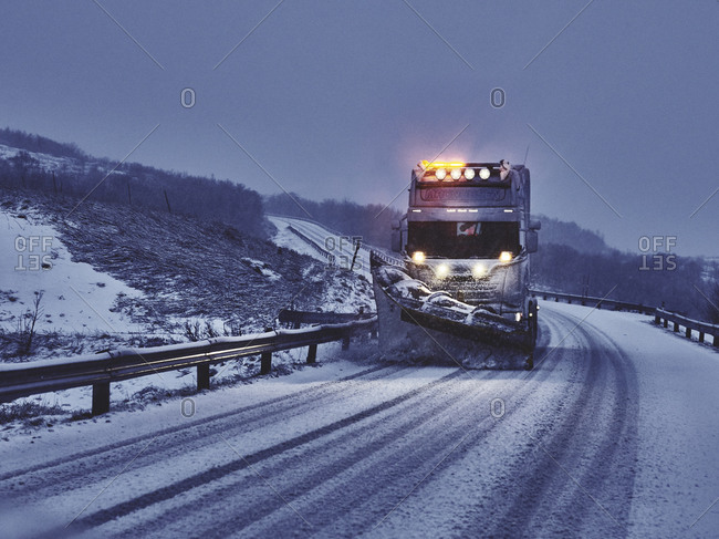 Plow truck plowing snow on a highway in the winter