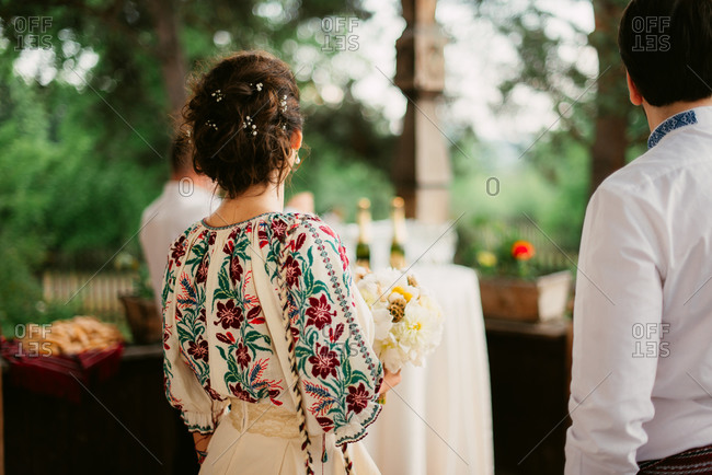 Back view of Romanian bride in traditional embroidered blouse