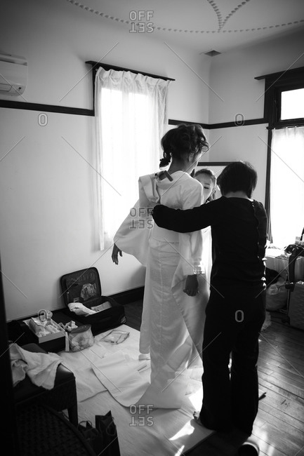 A Japanese bride dresses for her wedding