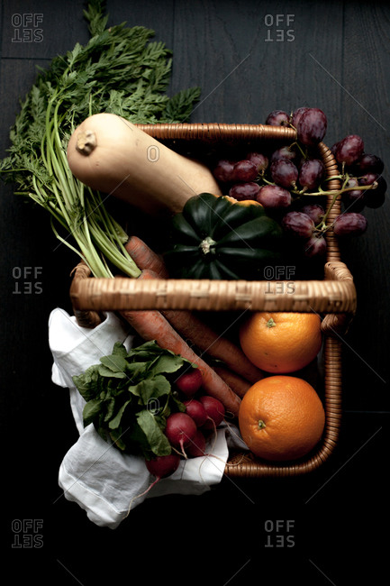 Overhead view of a basket filled with fruits and vegetables