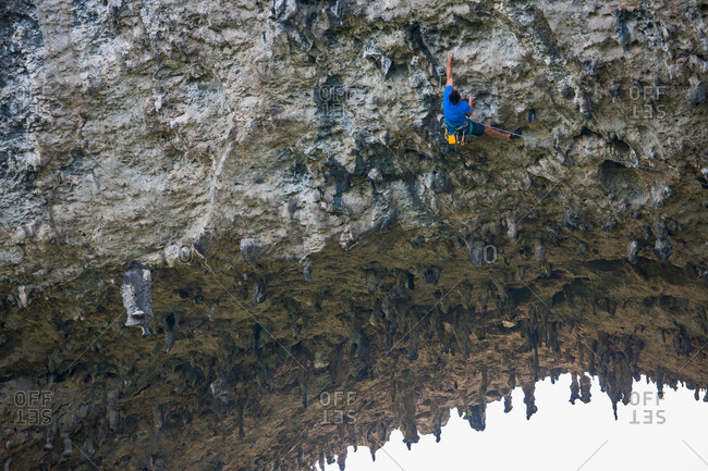 Rock climber on Moon Hill, Yangshuo, Guangxi Zhuang, China