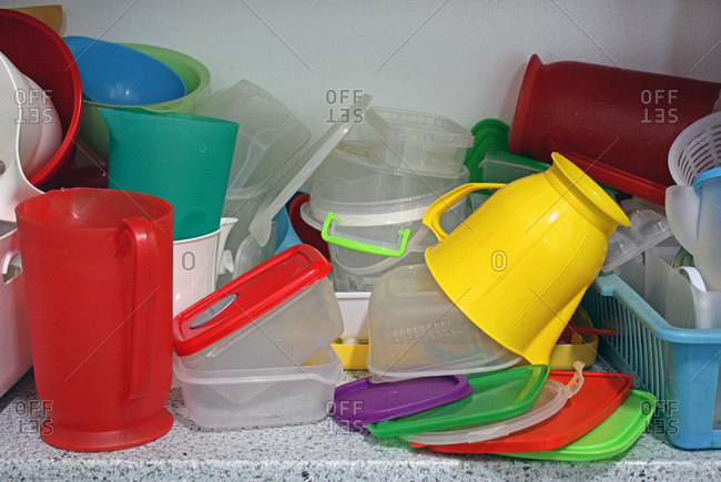 Plastic food storage containers and pitchers on a counter