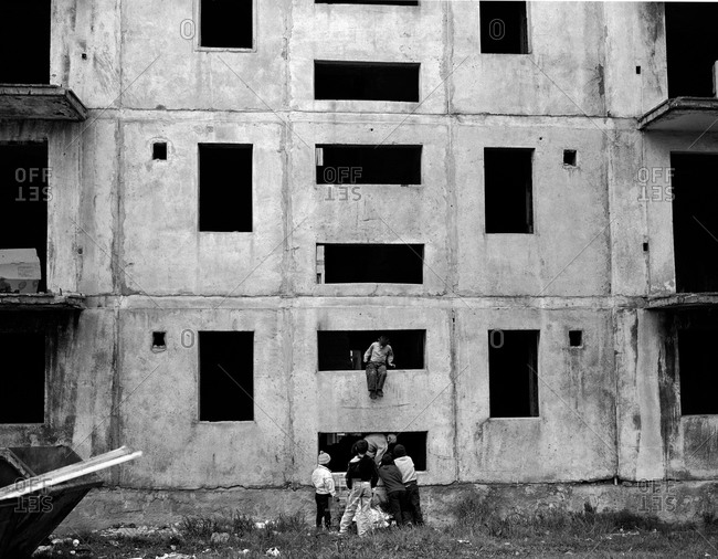 Children play in an unfinished communist style housing block in Copsa Mica, Transylvania, Romania