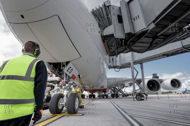 Engineer inspecting an aircraft at stand in an airport