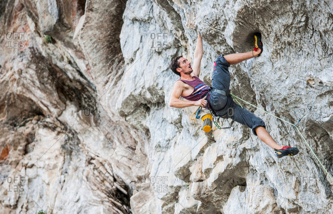 Male climber at Riverside crag in Yangshuo, Guangxi Zhuang, China