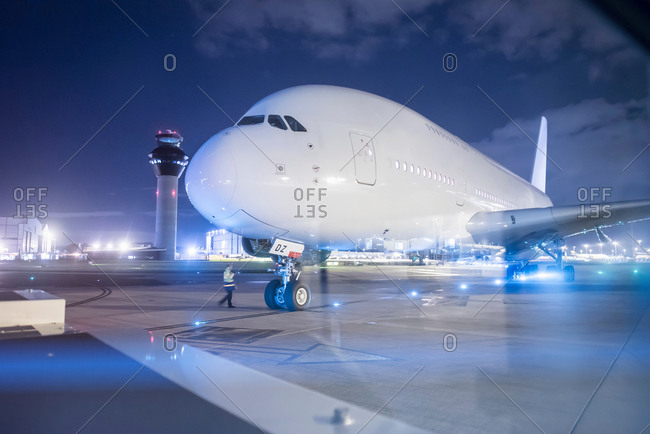 Engineer communicating with pilot of an aircraft on runway at night