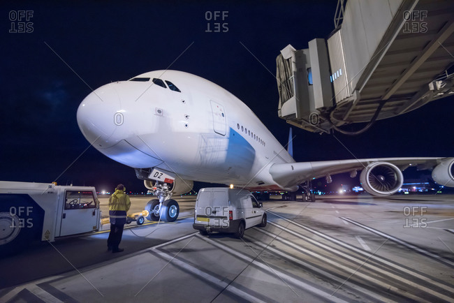 Chief engineer with an airplane on runway at night