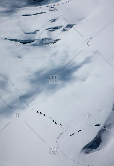 Distant high angle view of climbing team crossing glacier at  Mont Blanc, Chamonix, Haute Savoie, France