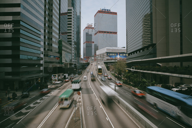 Blurred traffic on highway between buildings in Hong Kong