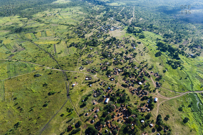 Small subsistence farms surround a village on a green plain near the Zambezi River