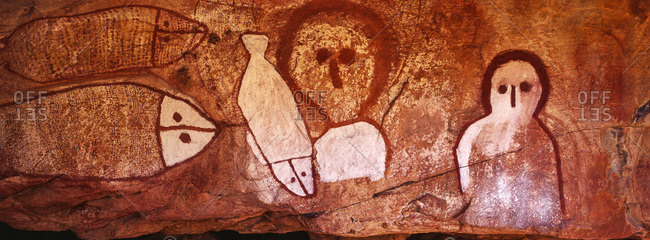 The rich ochre colours of an Aboriginal rock painting gallery featuring The Great Fish Chase