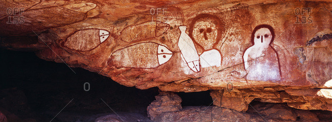 The rich ochre colours of an Aboriginal rock painting gallery featuring The Great Fish Chase