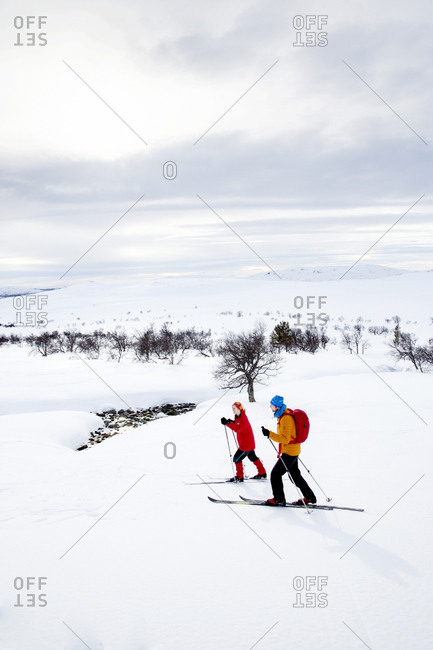 People skiing on cloudy day