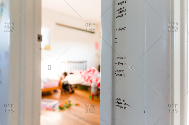 Height measurements marked off on wall between door frames