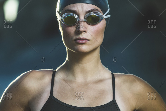 Portrait of a competitive swimmer with swim cap and goggles